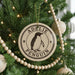 A Christmas tree decorated with ornaments, including a circular ornament with a penguin image and the text "ADELIE PENGUIN".