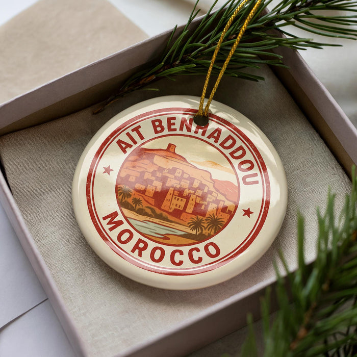 A decorative ornament in a box, featuring a circular design with a picture of a city and the text "AIT BENHADDOU MOROCCO".