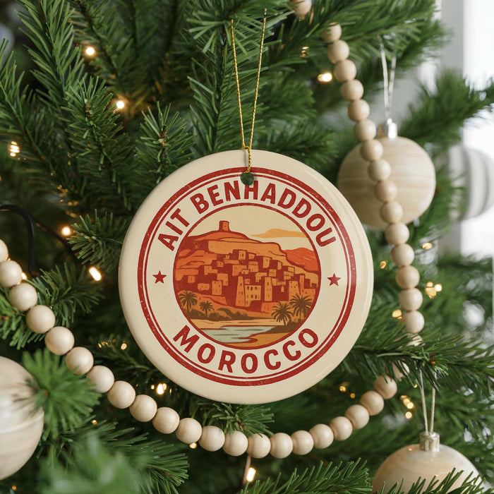 A circular ornament on a Christmas tree, featuring a picture of a city and the text "AIT BENHADDOU MOROCCO".