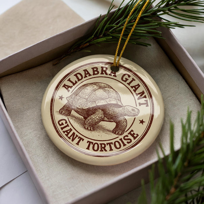 A circular ornament with the text "ALDABRA GIANT TORTOISE" printed on it, surrounded by pine branches.