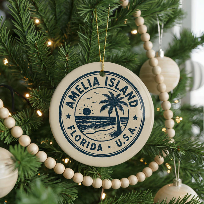 A Christmas tree decorated with ornaments, including a circular ornament with the text "AMELIA ISLAND FLORIDA U.S.A."