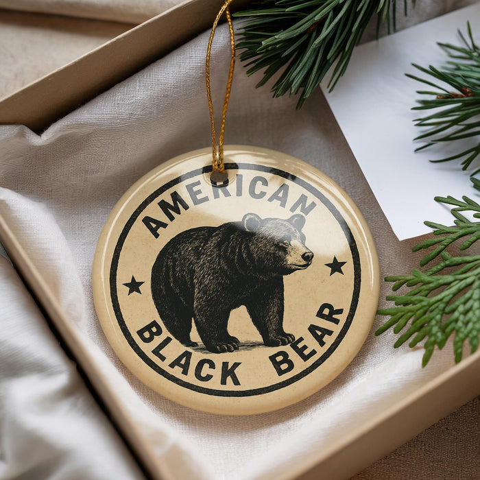 A circular ornament with a black bear image and the text "AMERICAN BLACK BEAR" is displayed in a box with pine branches.