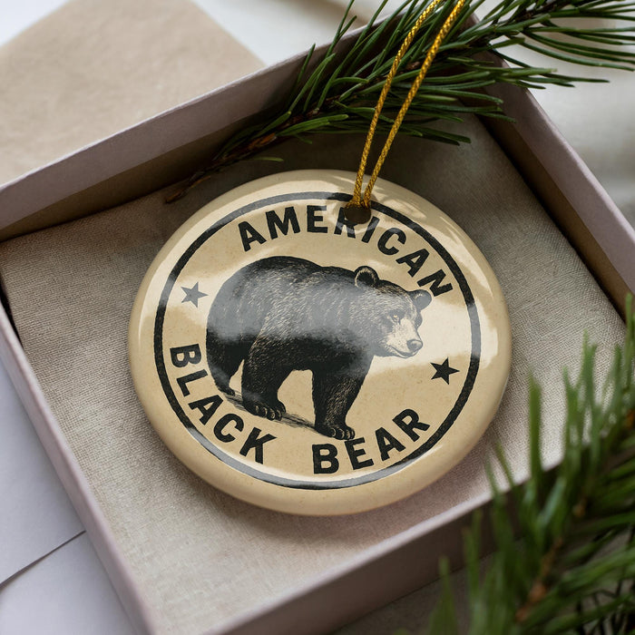 A circular ornament with the text "AMERICAN BLACK BEAR" printed on it, featuring a black bear image.