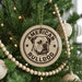 A Christmas tree decorated with ornaments, including a circular ornament with the text "AMERICAN BULLDOG" and a bulldog image.