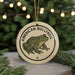 A circular ornament featuring an illustration of an American bullfrog, with the text "AMERICAN BULLFROG" printed on it.