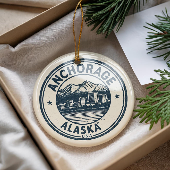 A circular ornament with the text "ANCHORAGE ALASKA USA" printed on it, hanging from a string.