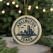 A circular ornament with the text "ARLINGTON TEXAS U.S.A." printed on it, featuring a graphic of a city skyline.