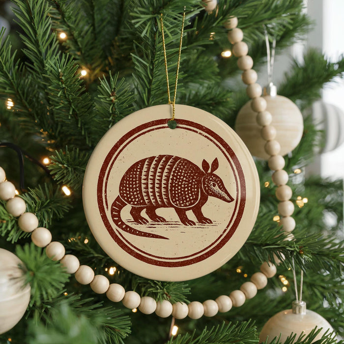 A Christmas tree decorated with ornaments, including a circular ornament featuring an armadillo design.