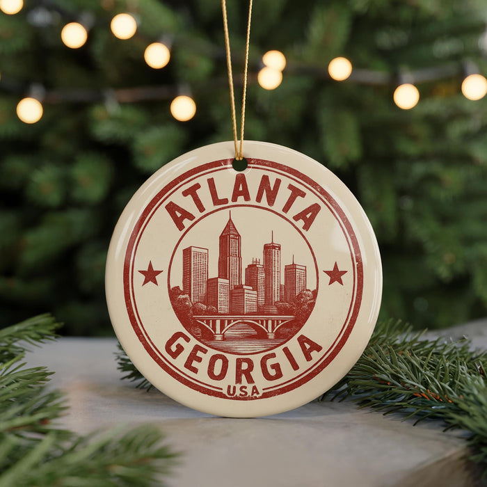 A circular ornament with the text "ATLANTA GEORGIA USA" printed on it, featuring a graphic of a city skyline.