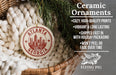 Ceramic ornaments featuring the city of Atlanta, Georgia, are displayed in a basket with greenery.