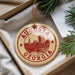 A circular ornament with the text "AUGUSTA GEORGIA" printed on it, hanging from a string.