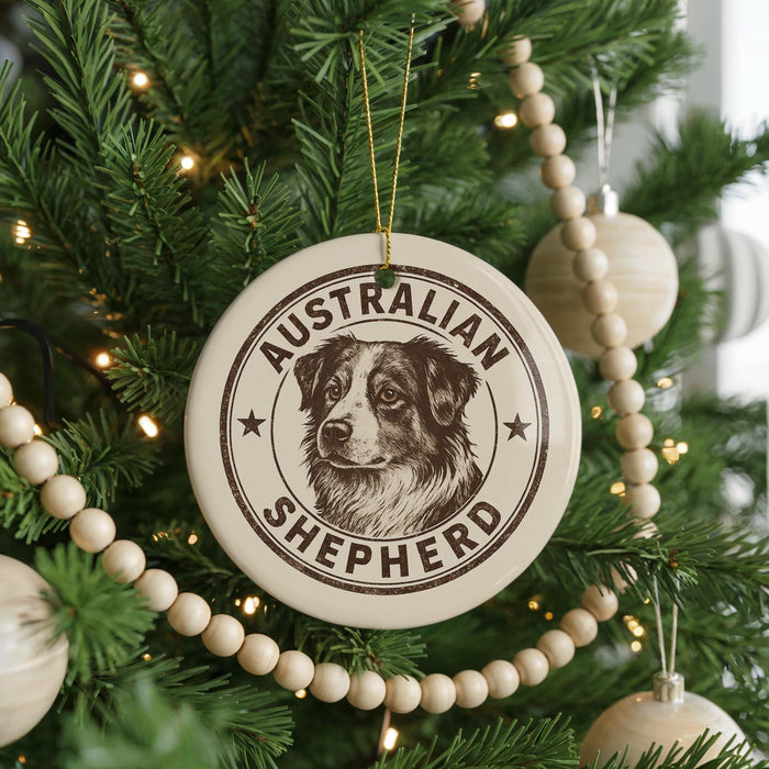 A Christmas tree decorated with ornaments, including a circular ornament with an image of an Australian Shepherd dog and the text "AUSTRALIAN SHEPHERD".