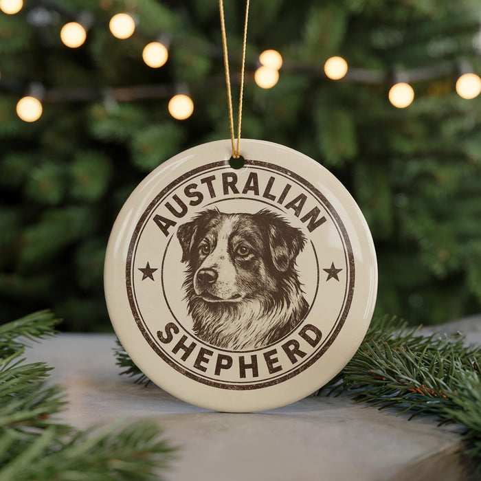 A circular ornament featuring an illustration of an Australian Shepherd dog, with the text "AUSTRALIAN SHEPHERD" printed on it.
