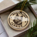 A circular ornament with the text "AUSTRALIAN TERRIER" printed on it, featuring a stylized illustration of a terrier dog's head.