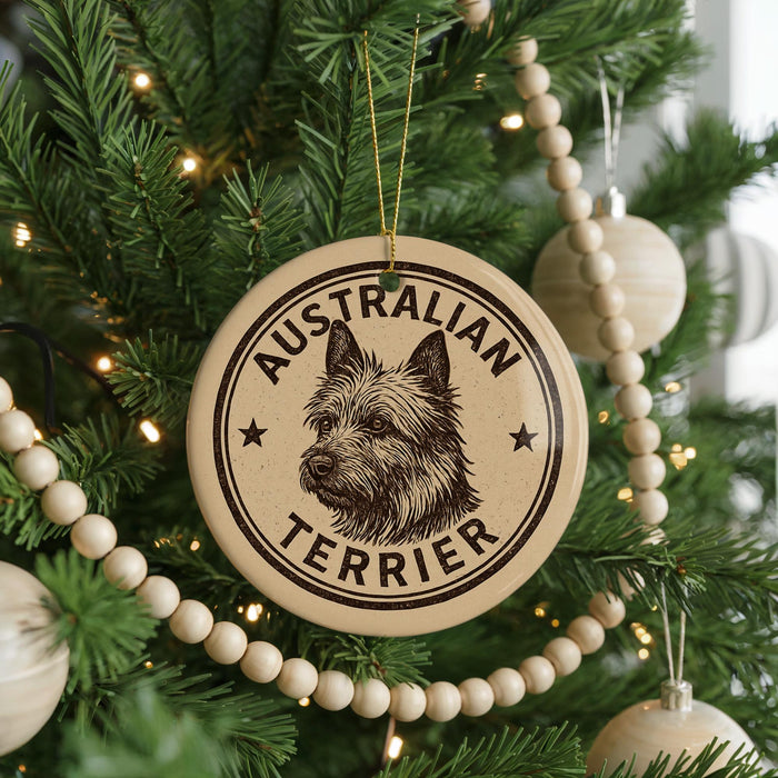A Christmas tree decorated with ornaments, including a circular ornament with a picture of a terrier dog and the text "AUSTRALIAN TERRIER".