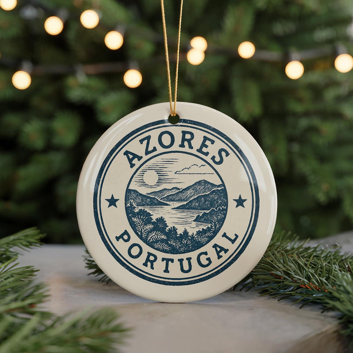 A circular ornament with the text "AZÓRES PORTUGAL" printed on it, surrounded by a landscape illustration.