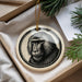 A decorative ornament featuring a close-up of a monkey's face, hanging from a string.