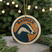 A circular ornament featuring a badger's head, with the word "BADGER" written around the edge.