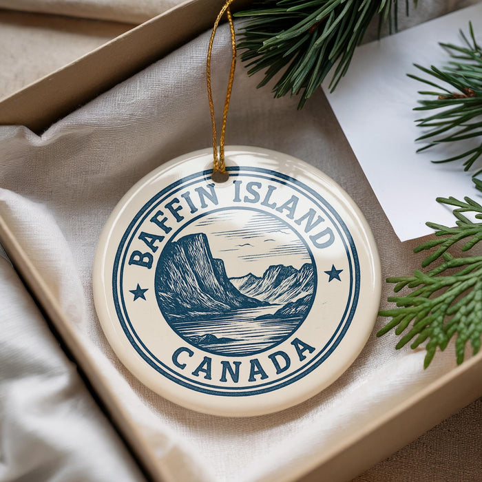 A circular ornament with the text "Baffin Island Canada" printed on it, hanging from a string.