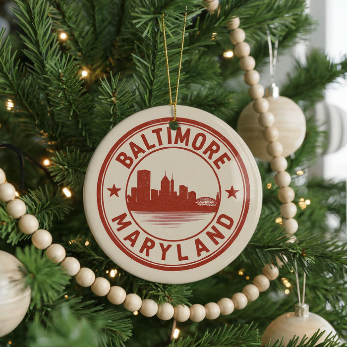A Christmas tree decorated with ornaments, including a circular ornament with the text "BALTIMORE MARYLAND" and a city skyline silhouette.