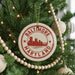 A Christmas tree decorated with ornaments, including a circular ornament with the text "BALTIMORE MARYLAND" and a city skyline silhouette.
