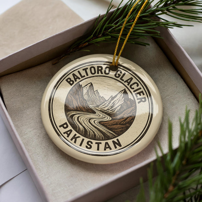 A circular ornament with the text "BALTORO GLACIER PAKISTAN" printed on it, surrounded by pine branches.