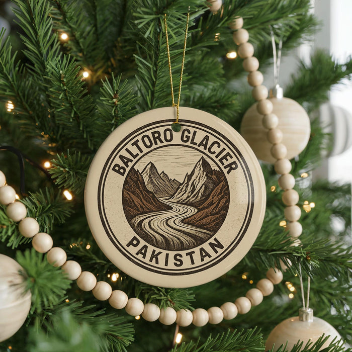 A Christmas tree decorated with ornaments, including a circular ornament with a mountain landscape and the text "BALTORO GLACIER PAKISTAN".