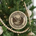 A Christmas tree decorated with ornaments, including a circular ornament with a mountain landscape and the text "BALTORO GLACIER PAKISTAN".
