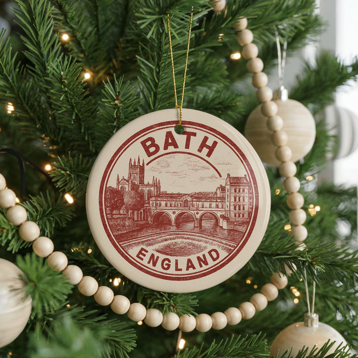 A circular ornament on a Christmas tree, featuring a drawing of a city and the text "BATH ENGLAND".
