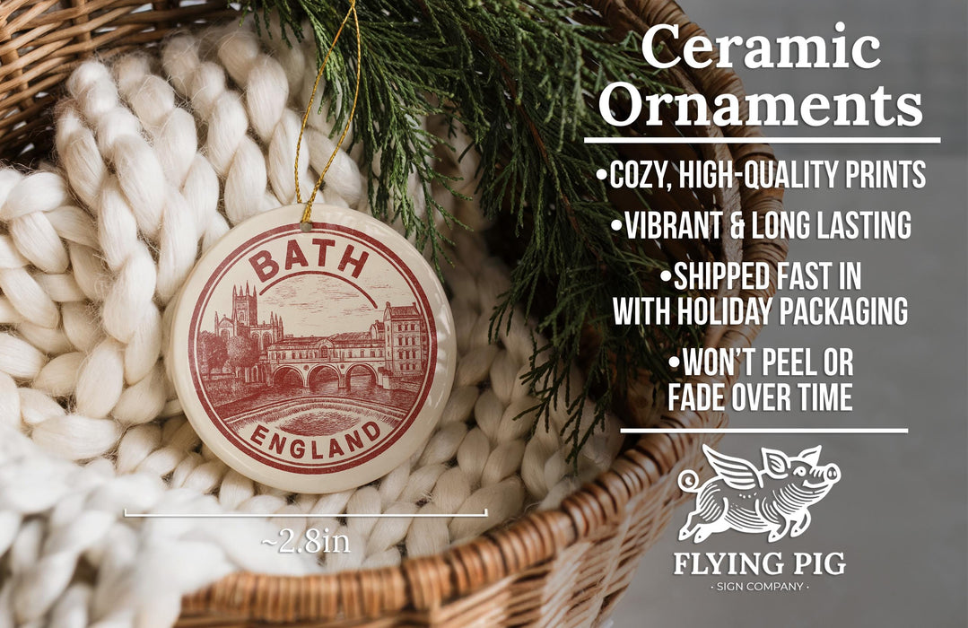 Ceramic ornaments, including a circular ornament with a red and white design, are displayed in a woven basket.