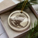 A ceramic ornament in the shape of a bearded dragon, with a detailed illustration of the animal on a white background.
