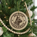A Christmas tree decorated with ornaments, including a circular ornament with a dog image and the text "Belgian Laekenois" printed on it.