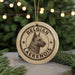A round ornament with a dog's head and the text "Belgian Laekenois" printed on it, hanging from a string.
