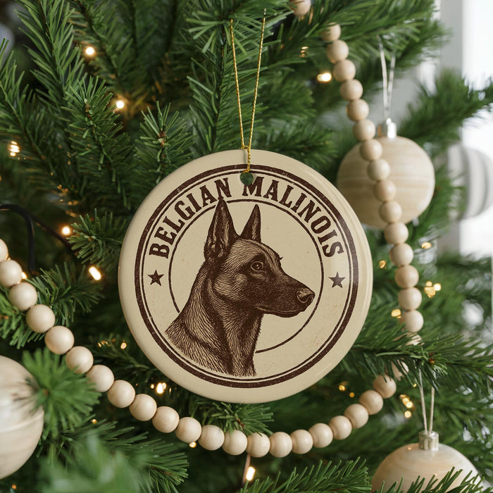 A Christmas tree decorated with ornaments, including a circular ornament featuring a dog's head and the text "Belgian Malinois".