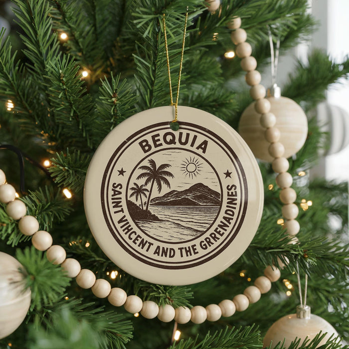 A Christmas tree decorated with ornaments, including a circular ornament with the text "BÉQUIA Saint Vincent and the Grenadines" and a palm tree design.