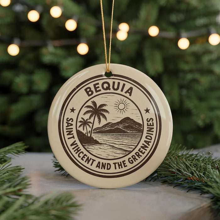 A round ornament with the text "BEQUIA SAINT VICENT AND THE GREPRADINES" printed on it, surrounded by pine branches and a blurred background of Christmas lights.