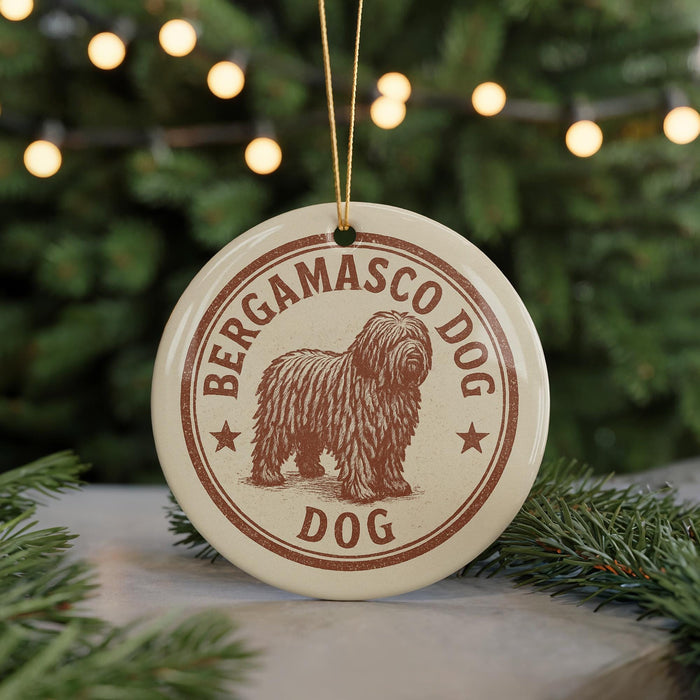 A round ornament with the text "BERGAMASCO DOG" and an illustration of a shaggy dog, hanging from a string.