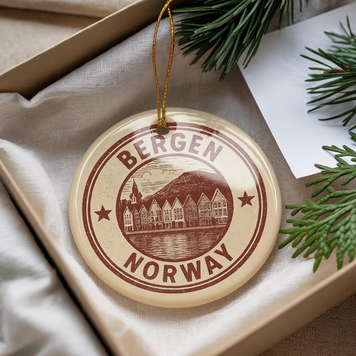 A round ornament with the text "BERGEN NORWAY" printed on it, hanging from a string.