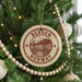 A Christmas tree decorated with ornaments, including a circular ornament with the text "BERGEN NORWAY" and a scenic illustration of a town.