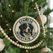 A Christmas tree decorated with ornaments, including a circular ornament with a Bernese Mountain Dog image and the text "BERNESE MOUNTAIN DOG".
