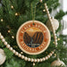 A circular ornament on a Christmas tree, featuring the text "BLACK CANYON OF THE NATIONAL PARK" and an illustration of a canyon landscape.