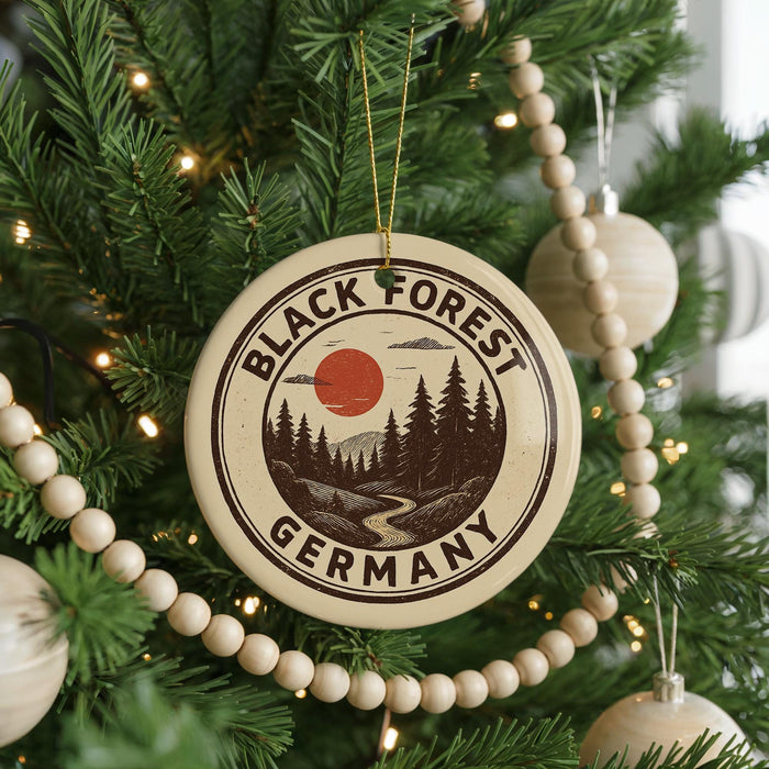 A Christmas tree decorated with ornaments, including a circular ornament with the text "BLACK FOREST GERMANY" and a sun-like symbol.