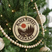 A Christmas tree decorated with ornaments, including a circular ornament with the text "BLACK FOREST GERMANY" and a sun-like symbol.