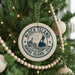 A Christmas tree decorated with ornaments, including a circular ornament with the text "BLOCK ISLAND RHODE ISLAND USA" and a lighthouse image.
