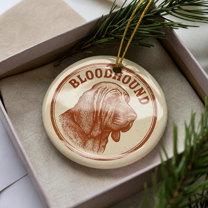 A circular ornament with the word "Bloodhound" printed on it, featuring a close-up illustration of a Bloodhound dog's head.