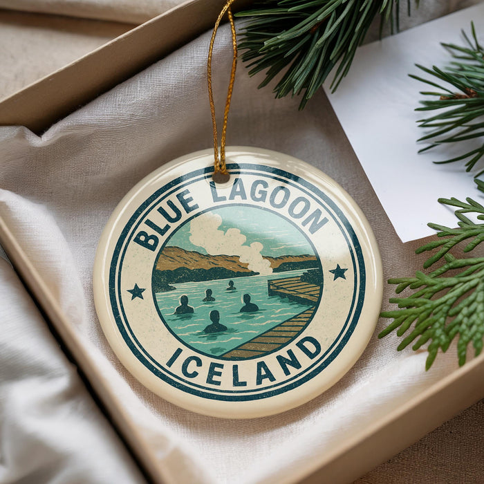 A circular ornament with the text "BLUE LAGOON ICELAND" and an illustration of a lake with people swimming, hanging from a string.