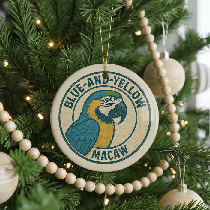 A Christmas tree decorated with ornaments, including a circular ornament with a parrot design and the text "BLUE-AND-YELLOW MACAW" on it.