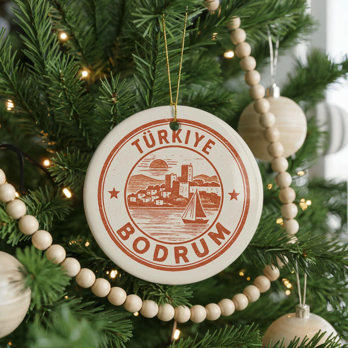A Christmas tree decorated with ornaments, including a circular ornament with the text "TURKİE BODrum" and a sailboat illustration.