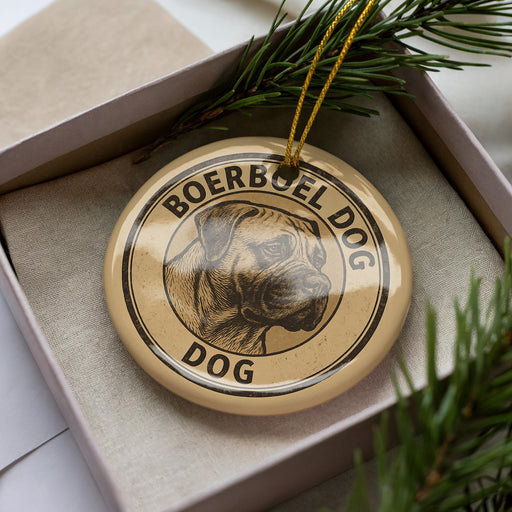 A circular ornament with the text "BOERBEL DOG" and a dog image is displayed in a box, surrounded by pine branches.