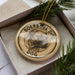 A circular ornament with the text "BOERBEL DOG" and a dog image is displayed in a box, surrounded by pine branches.